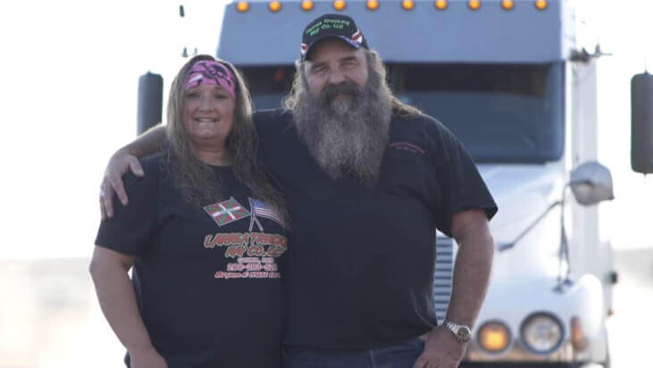 Bryan and Nikki Larrea stand in front of one of their trucks