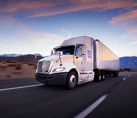 Truck on the highway at sunrise.