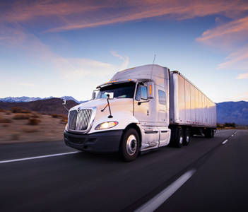 Truck on the highway at sunrise.
