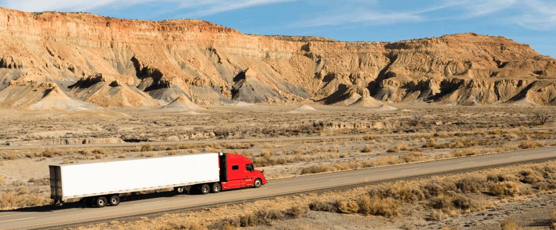 truck driving down desert highway