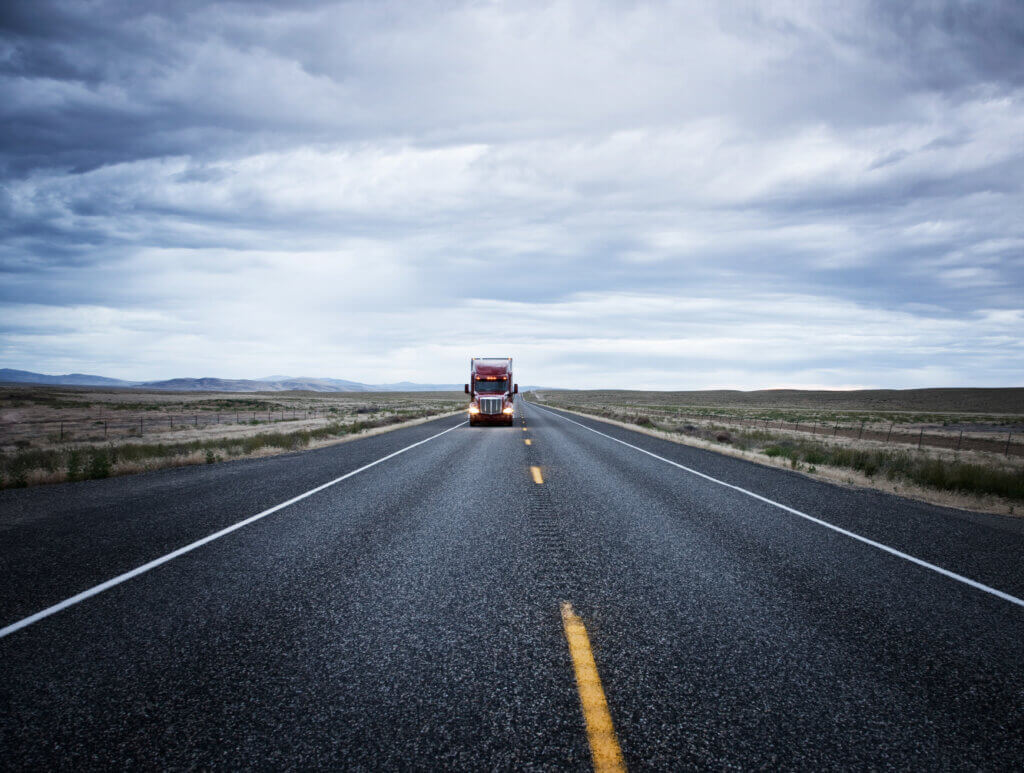 Semi truck driving down a highway