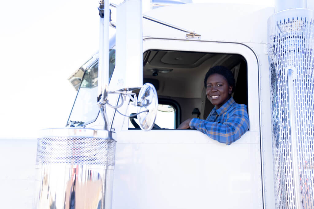 African American woman sitting in a white semi truck